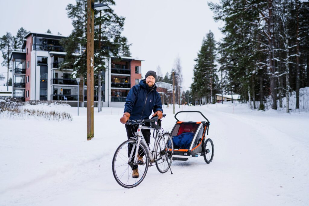 A man cycling with a child.